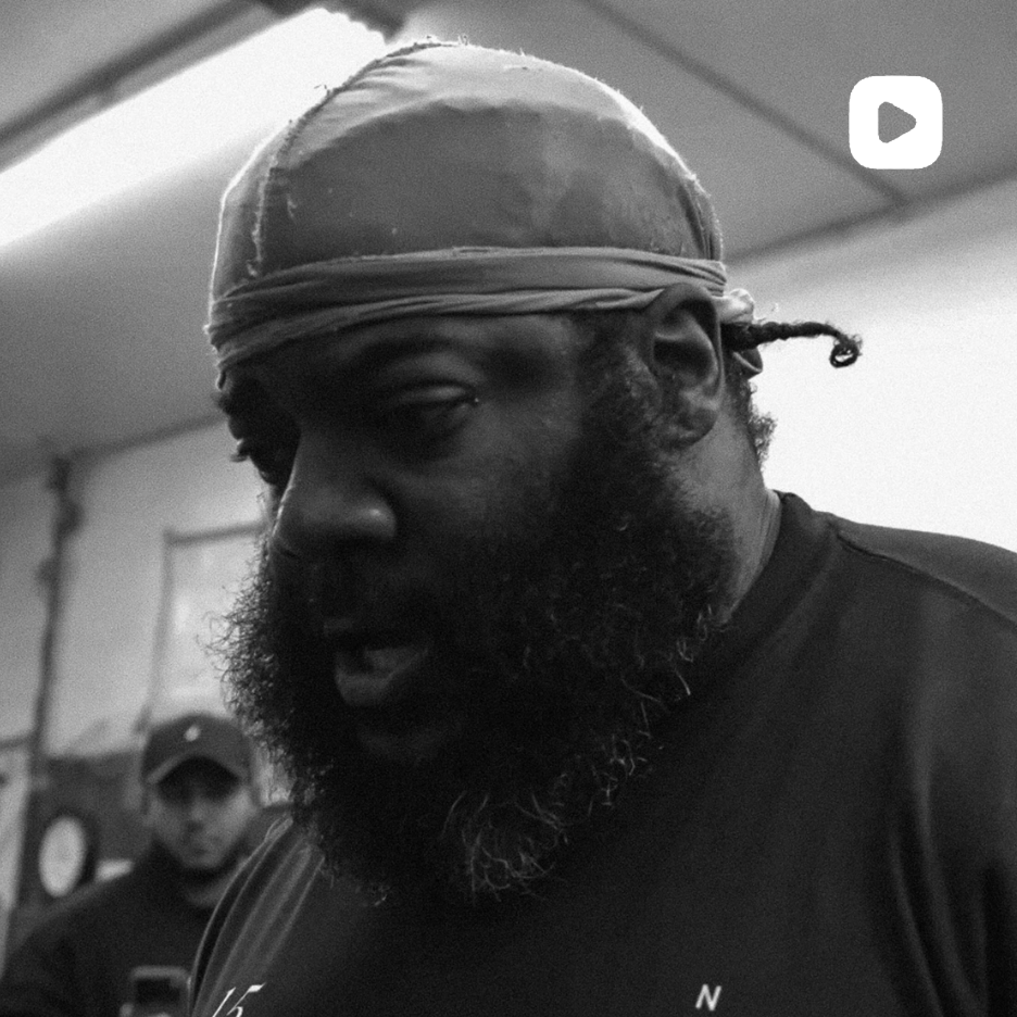 Close-up of a bearded man wearing a durag standing in a gym, black-and-white Instagram video thumbnail